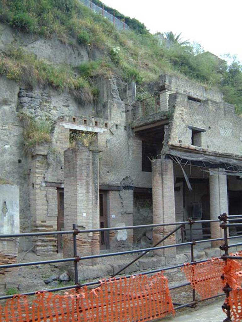 Decumanus Maximus, Herculaneum, May 2001. Looking towards north side with doorway numbered 1, in centre behind pillar, and portico. Photo courtesy of Current Archaeology.